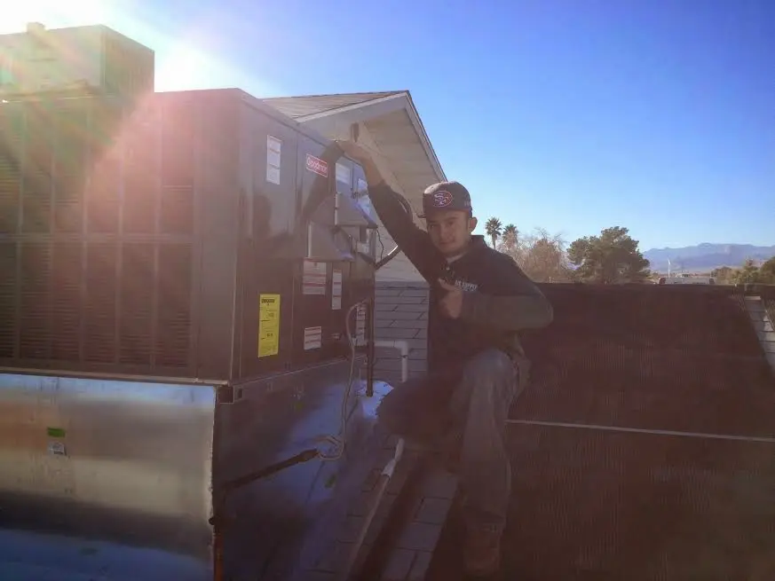 HVAC technician performing Heat Pump Repair on a rooftop unit in Rio Vista