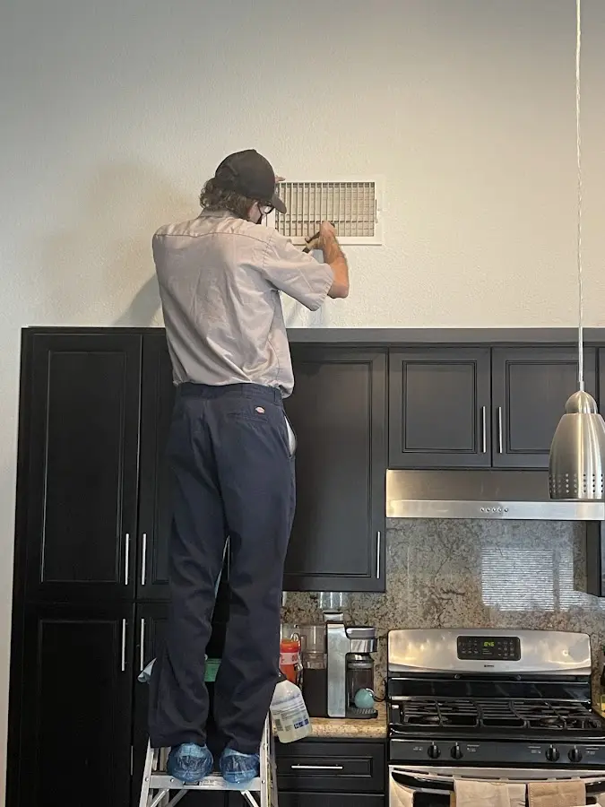 Technician inspecting an air vent during HVAC service in Rio Vista